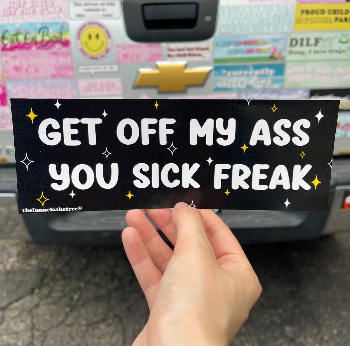 Bumper sticker with black background and white and yellow sparkles. White text reads Get Off My Ass You Sick Freak