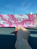 Pink Galaxy background on a bumper sticker being held by The Funnel Cake Tree 