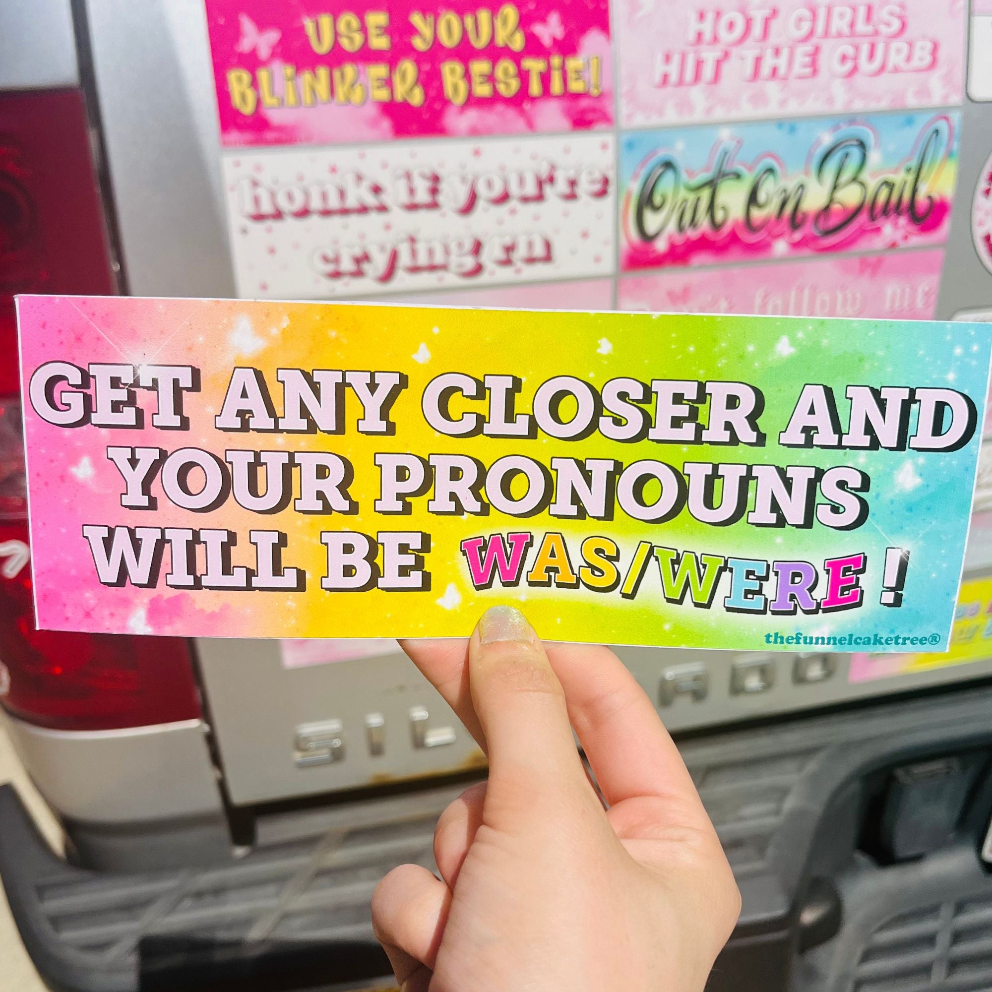  “Funny vinyl bumper sticker that says ‘If You Get Any Closer Your Pronouns will be was/were’ — waterproof and UV-protected, perfect for cars.”
