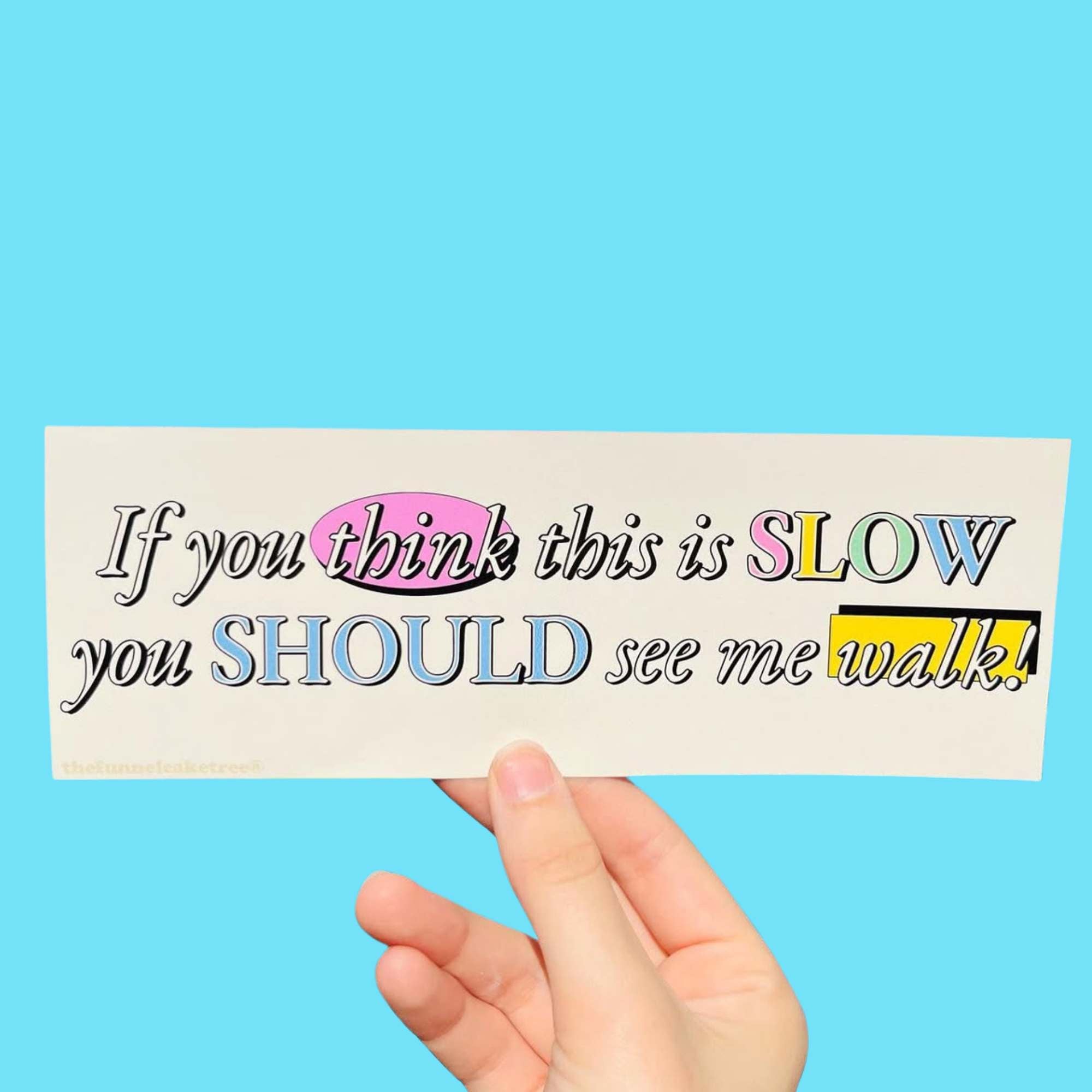  Glossy cream bumper sticker with mixed fonts and pastel highlights reading “If you think this is slow you should see me walk.”