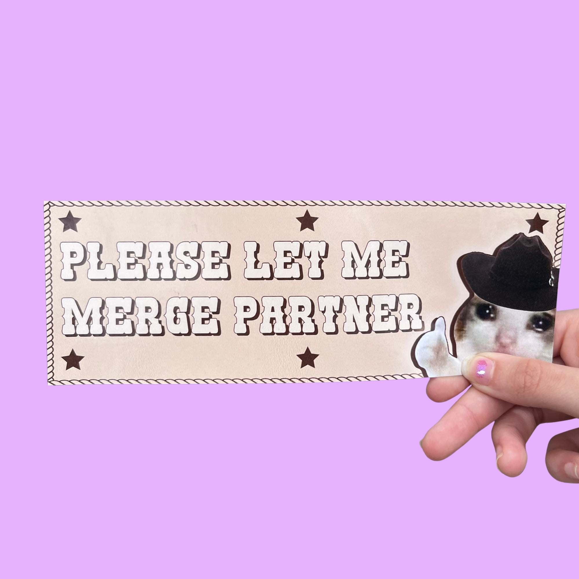 Glossy beige bumper sticker with bold western-style text reading “Please let me merge partner” and an image of a cowboy cat tipping its hat.