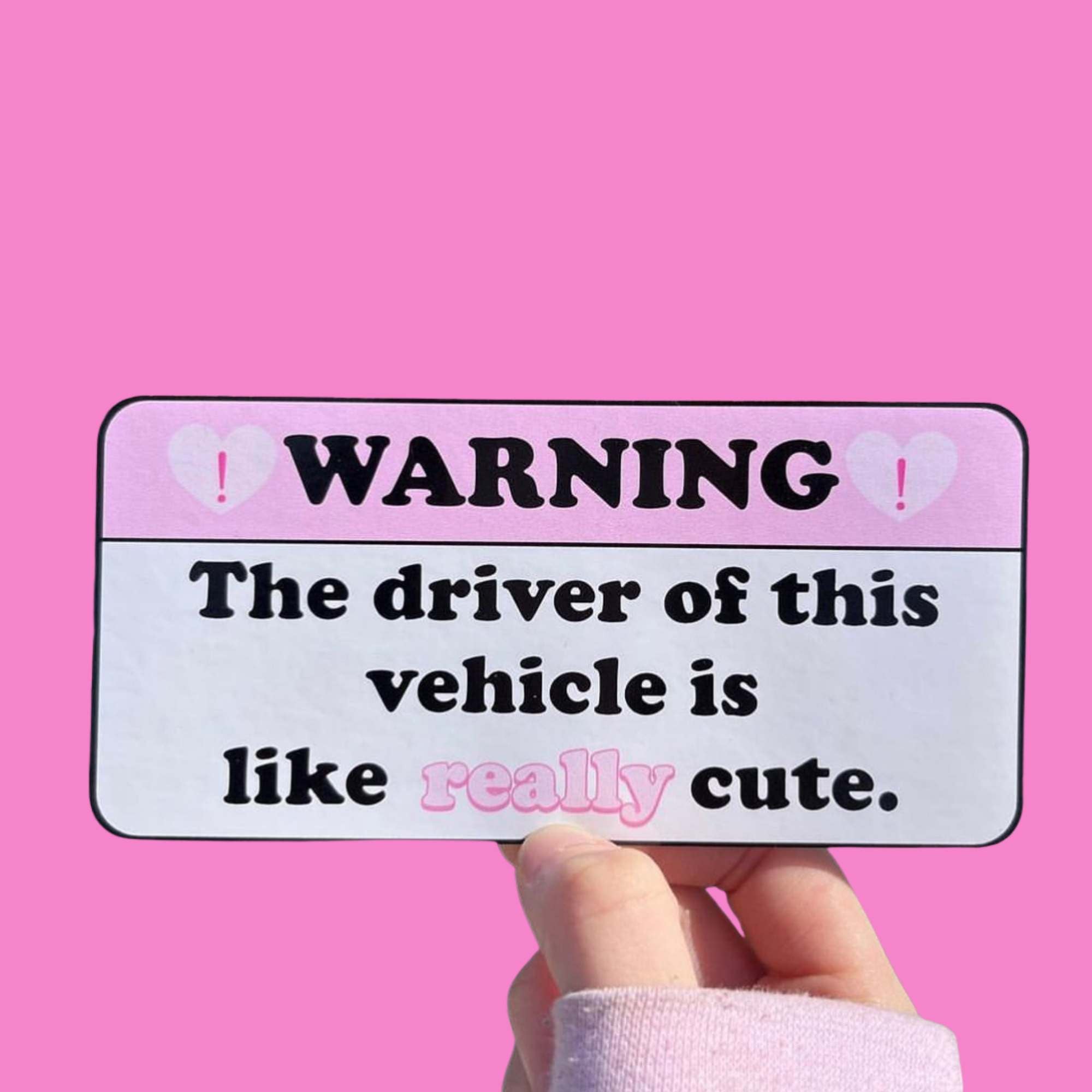  “Funny vinyl bumper sticker that says ‘Warning the driver of this vehicle is like really cute’ — waterproof and UV-protected, perfect for cars.”
