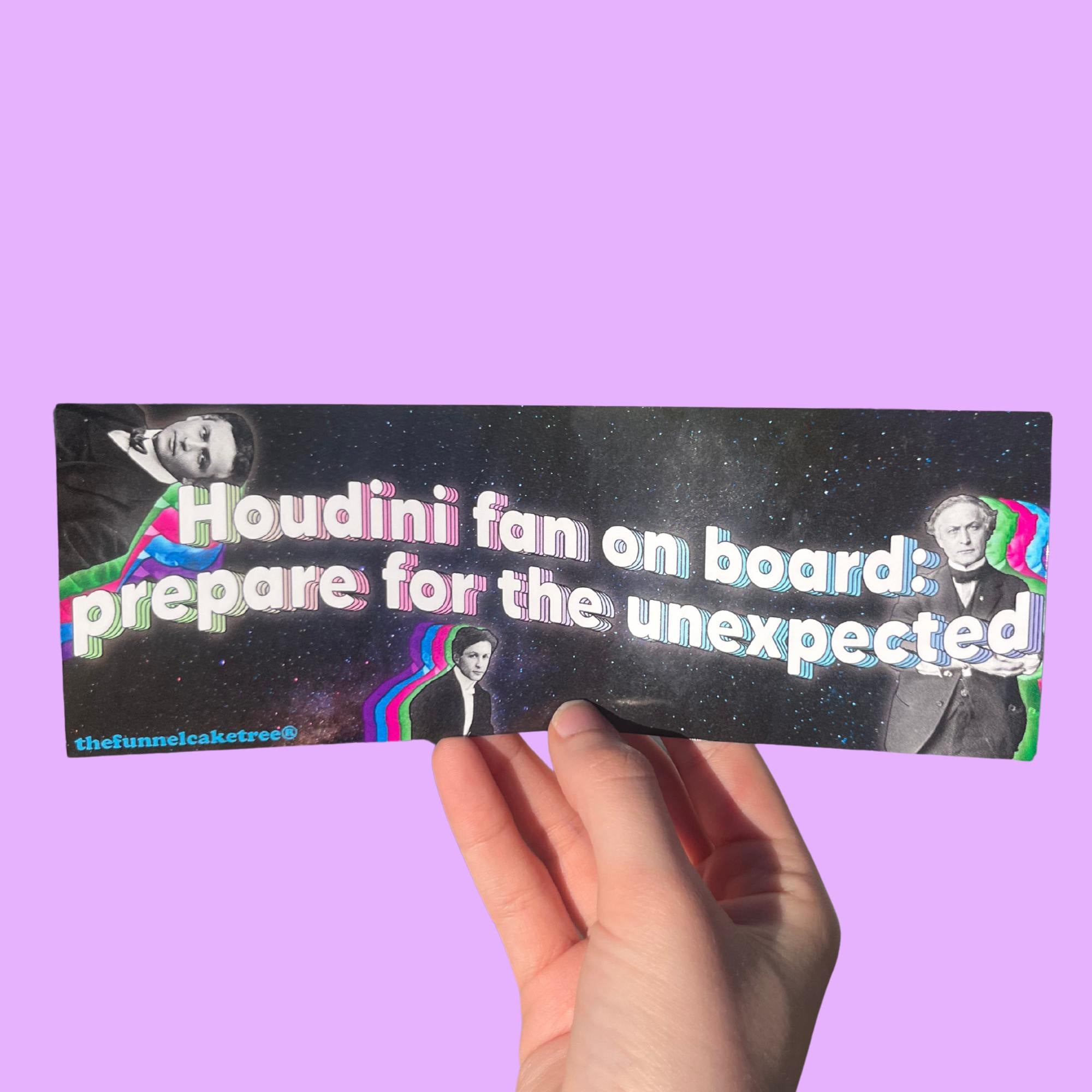Glossy black bumper sticker with white and pink text reading “Houdini fan on board; prepare for the unexpected,” featuring vintage Houdini portraits with colorful glitch effects on a starry background.