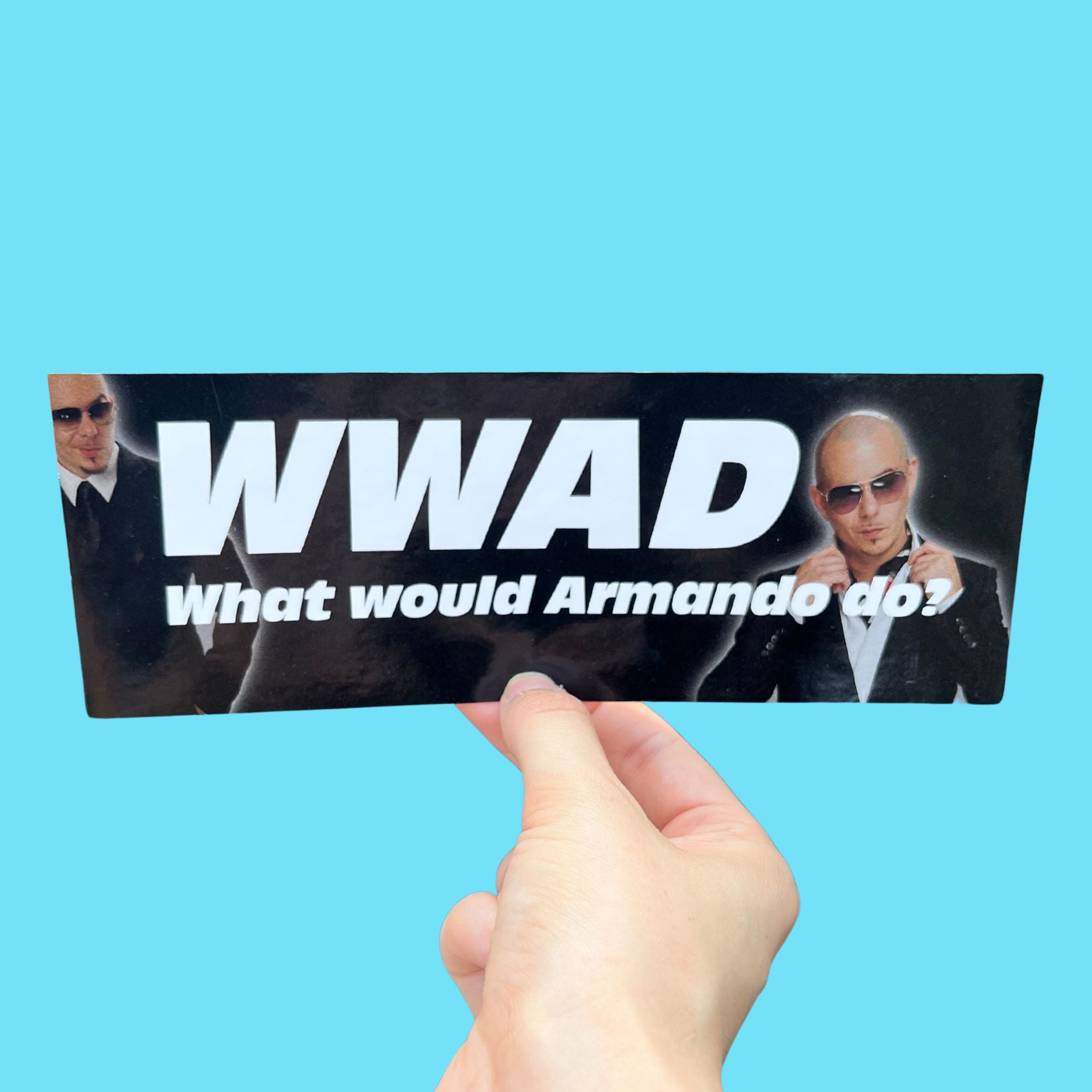 Glossy black bumper sticker with white text reading “WWAD What would Armando do?” and two images of a bald man in sunglasses and a suit.
