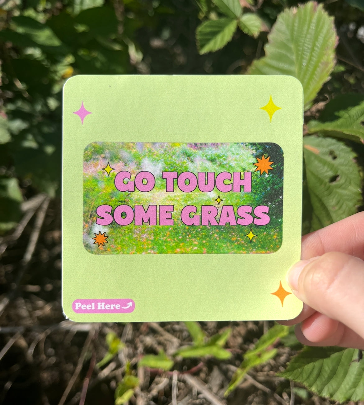 “Funny vinyl sticker that says ‘go touch some grass’ — waterproof and UV-protected, perfect for cars, water bottles, notebooks, laptops, skateboards, etc