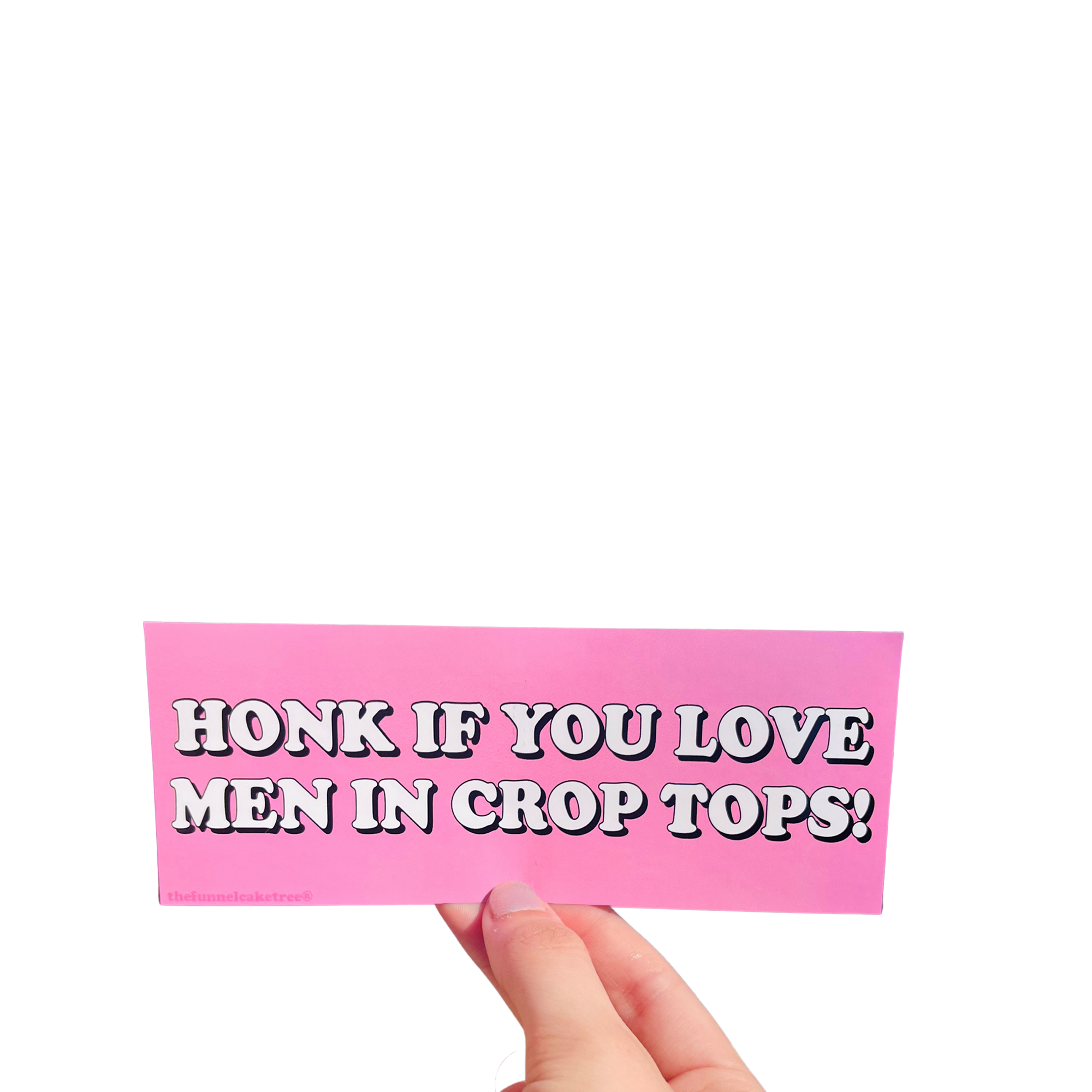 Hand holding a pink mini bumper sticker reading 'Honk if you love men in crop tops!' in white lettering.