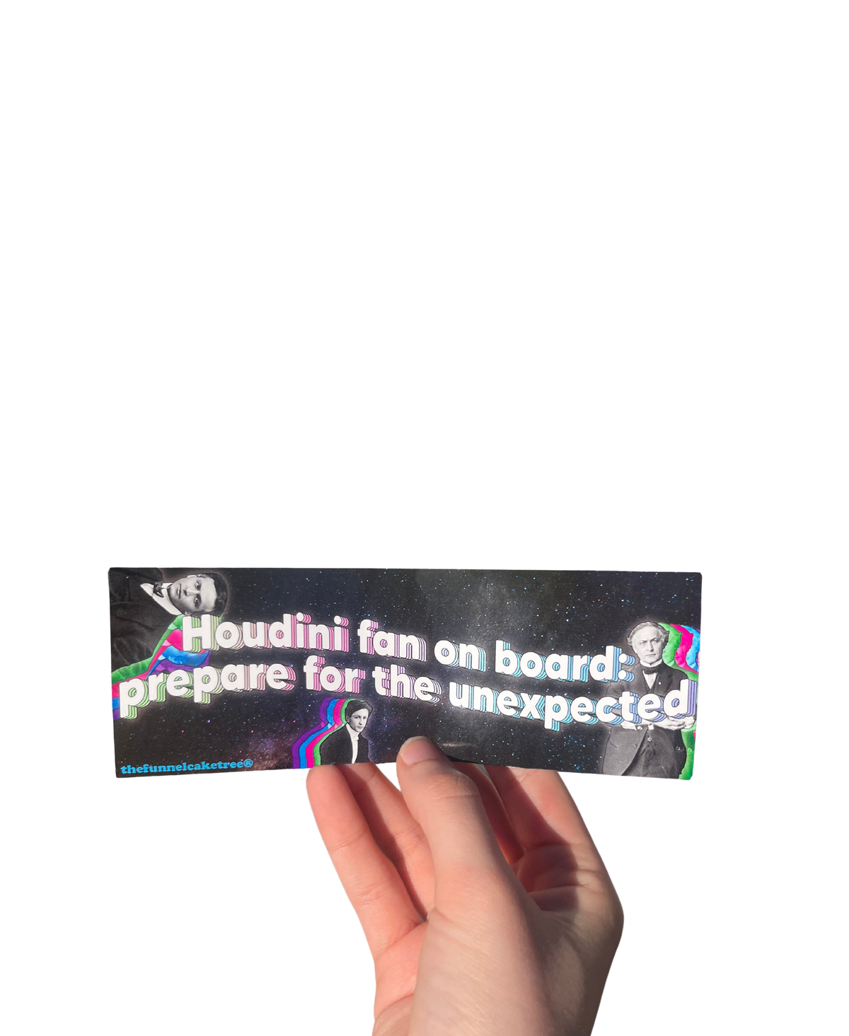 Hand holding a black 'Houdini fan on board: prepare for the unexpected' mini sticker with magician portraits.