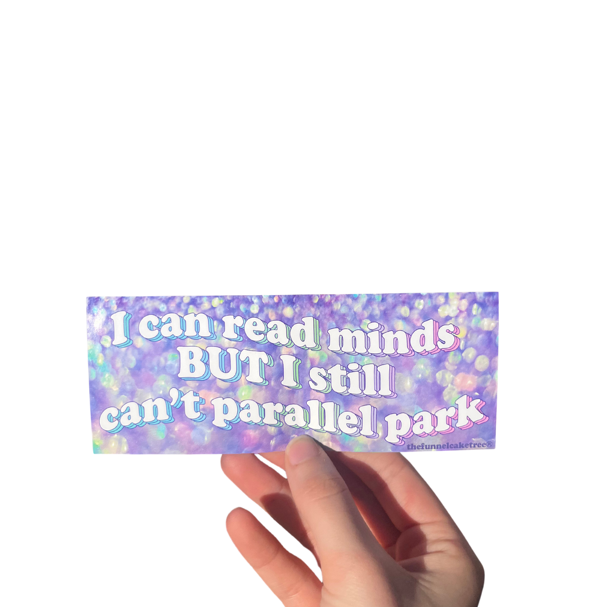 Hand holding a purple iridescent mini bumper sticker reading 'I can read minds BUT I still can't parallel park'.