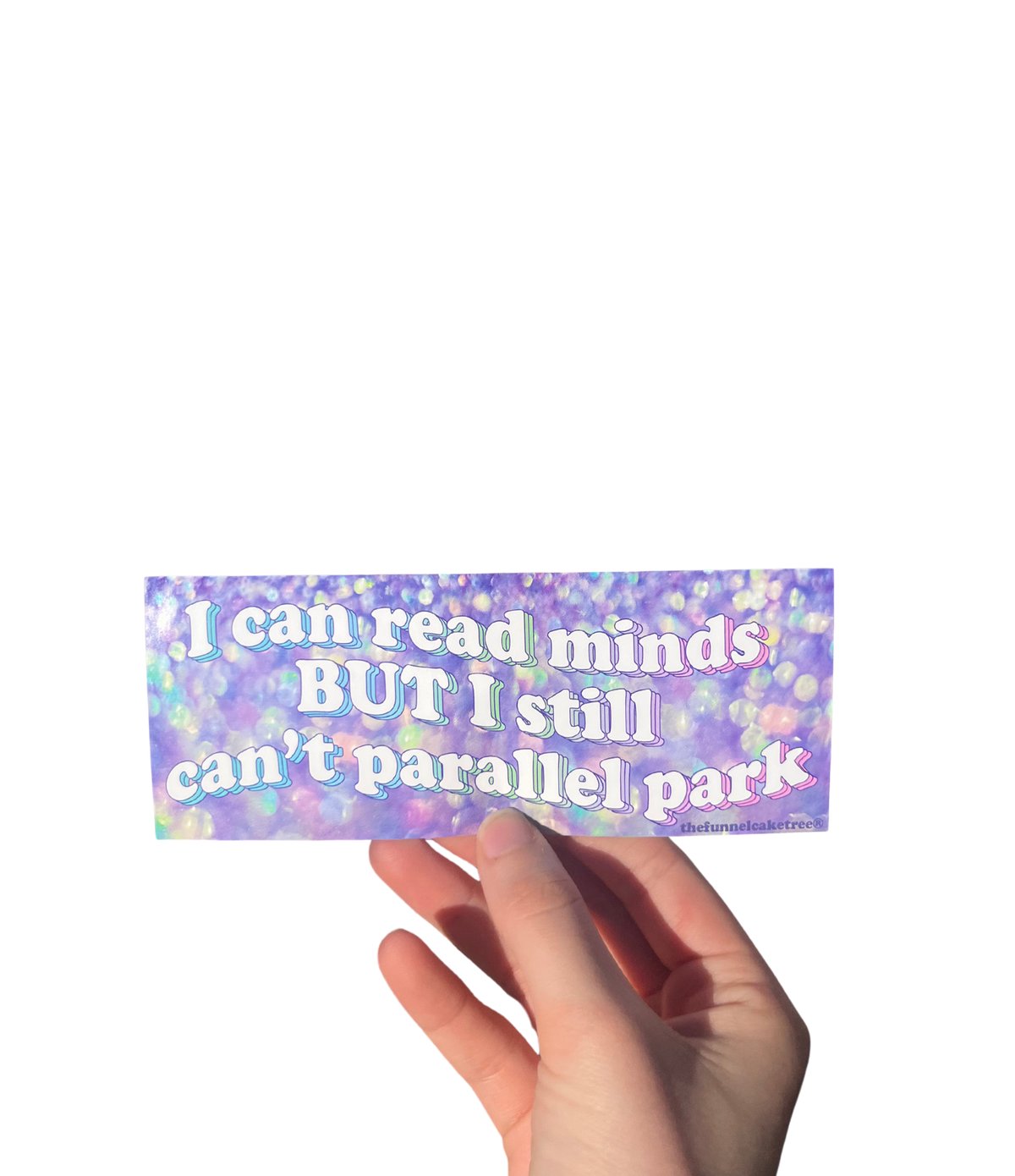 Hand holding a purple iridescent mini bumper sticker reading 'I can read minds BUT I still can't parallel park'.