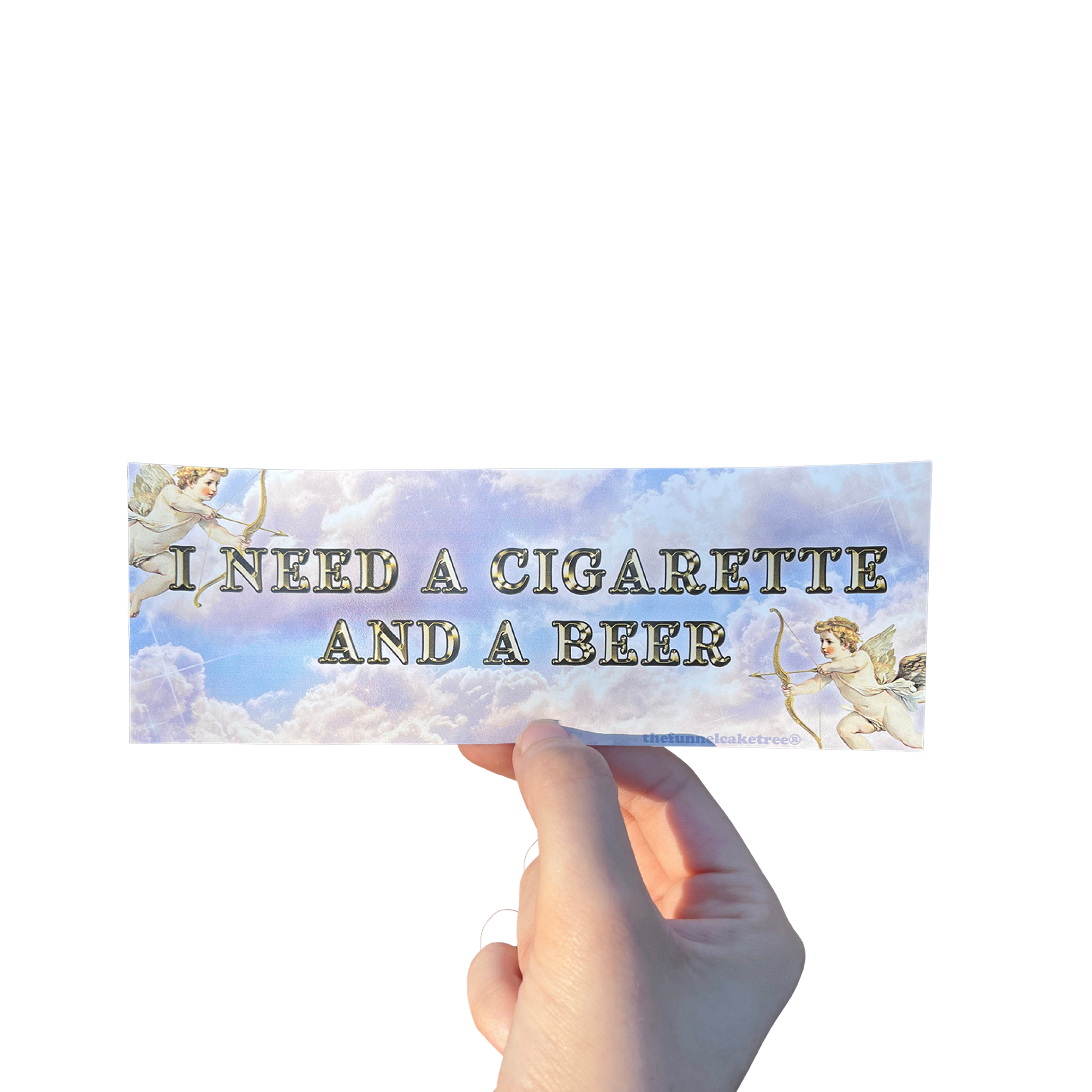 Hand holding a cloudy mini bumper sticker reading 'I NEED A CIGARETTE AND A BEER' beside a cherub illustration.