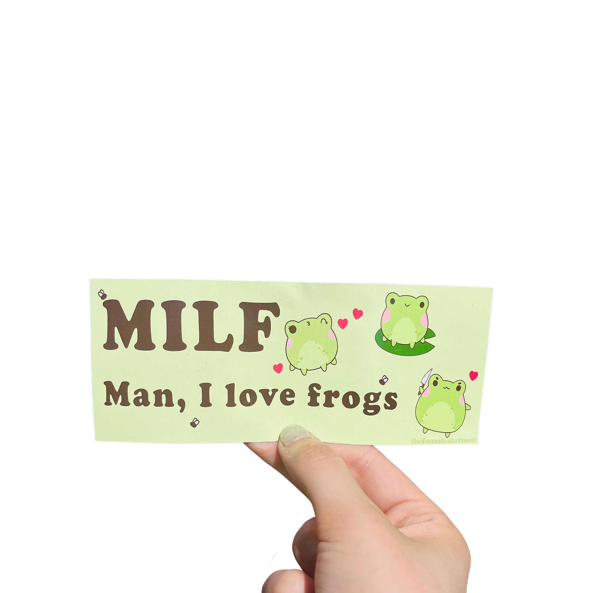 Hand holding a green mini bumper sticker reading 'MILF — Man, I love frogs' with cartoon frogs and hearts.