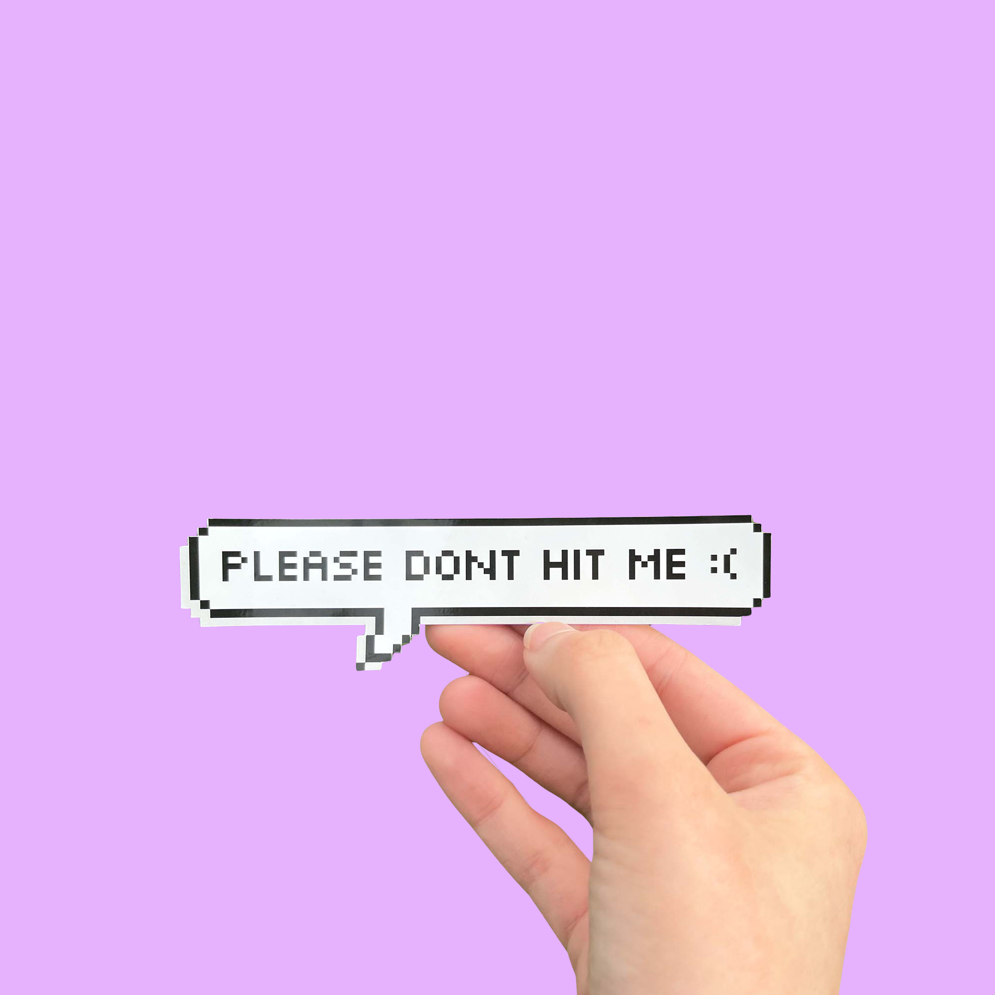 Hand holding a mini bumper sticker reading "please dont hit me." On a solid purple background.