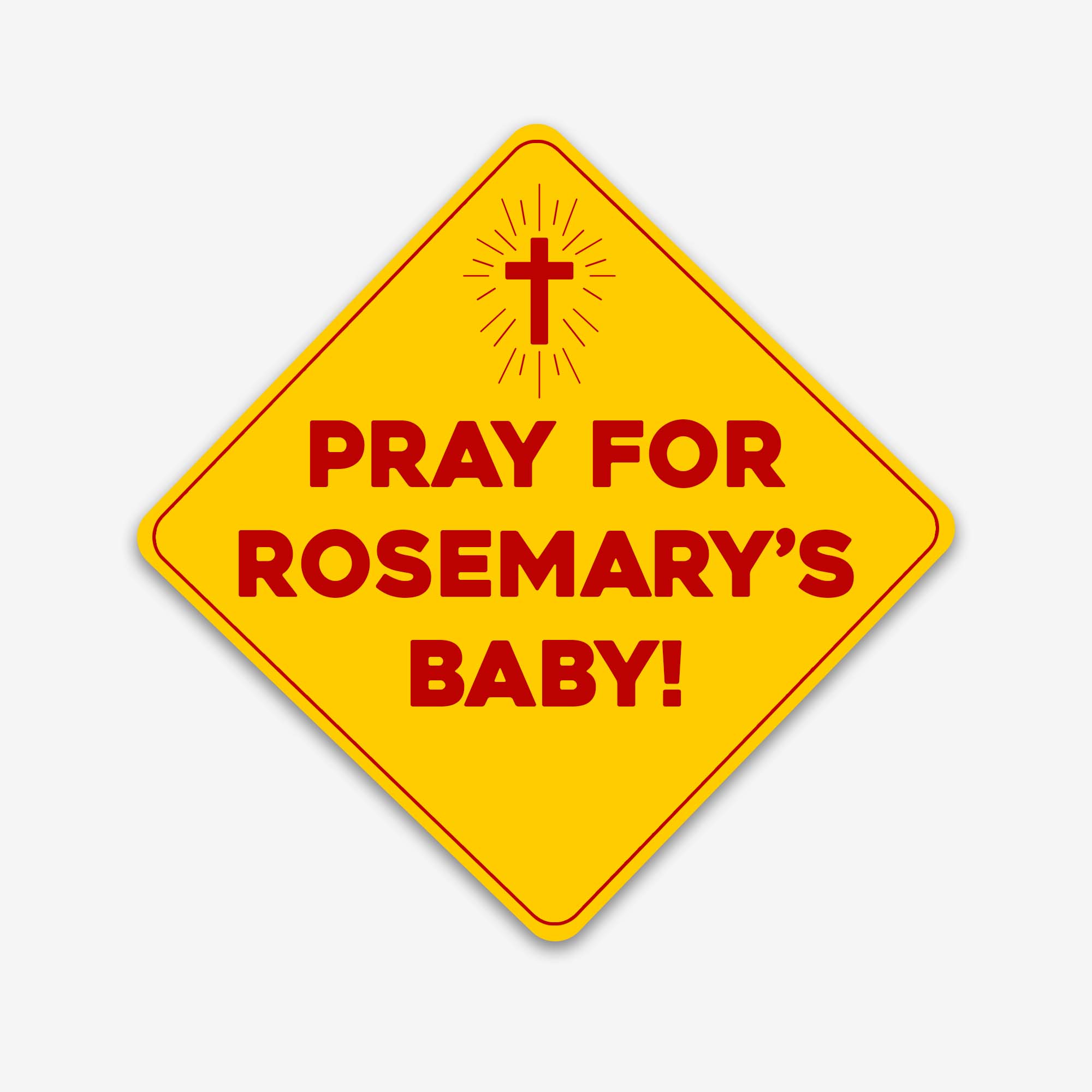 Glossy yellow diamond-shaped bumper sticker with red text reading “Pray for Rosemary’s Baby” and a glowing cross icon above.