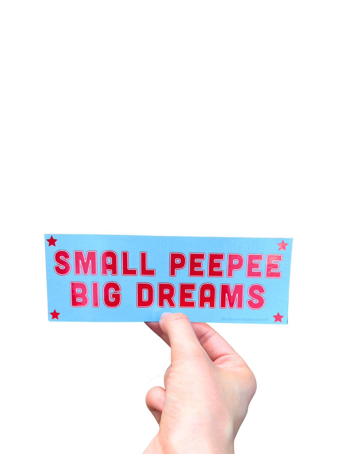 Hand holding a blue mini bumper sticker reading 'SMALL PEEPEE BIG DREAMS' in red letters with stars.