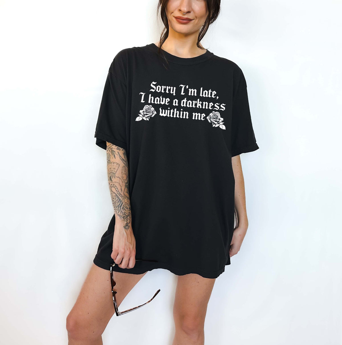 Black short-sleeve fabric t-shirt with Sorry I’m late, I have a darkness within me and two roses printed in white.