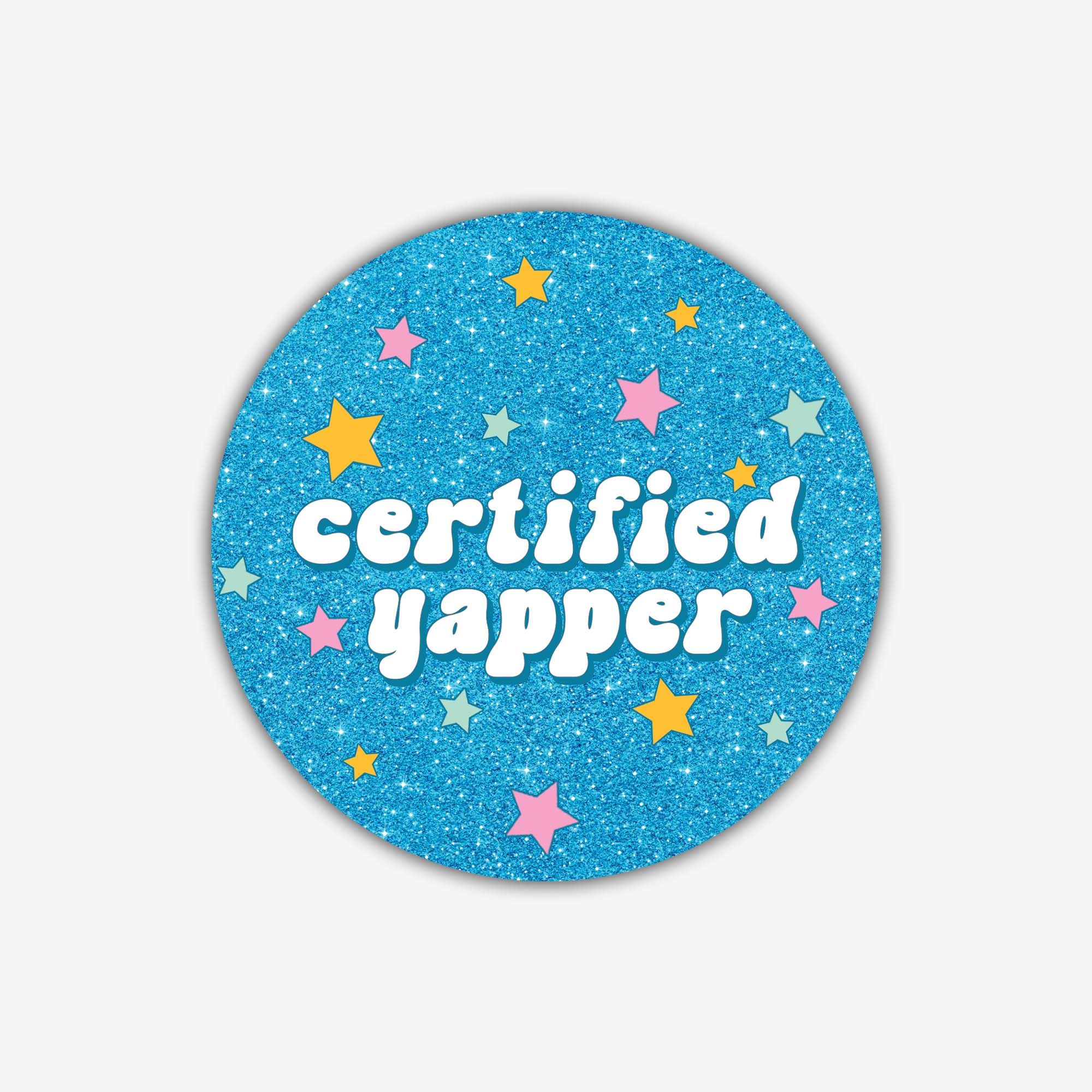 Round blue glitter sticker with 'certified yapper' text and colorful stars on a light gray background