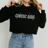 The Funnel Cake Tree “Cosmic Babe” cropped black hoodie with white retro lettering and star accents, styled with high-waisted jeans for a fun and casual cosmic look