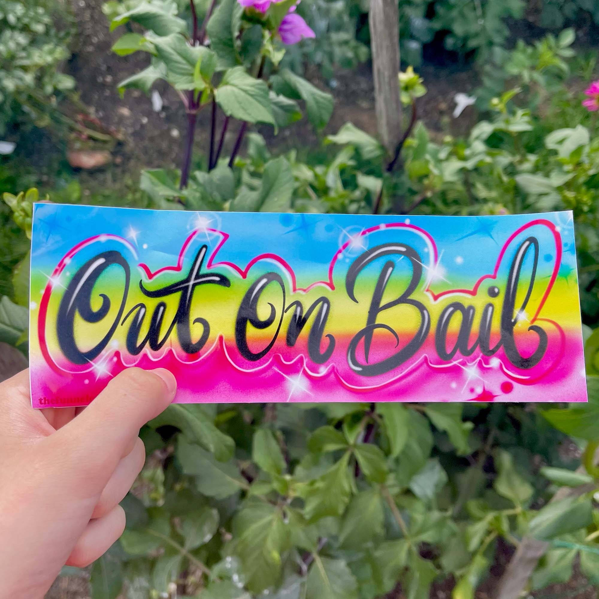  “Funny vinyl bumper sticker that says ‘Out on Bail’ — waterproof and UV-protected, perfect for cars.”

