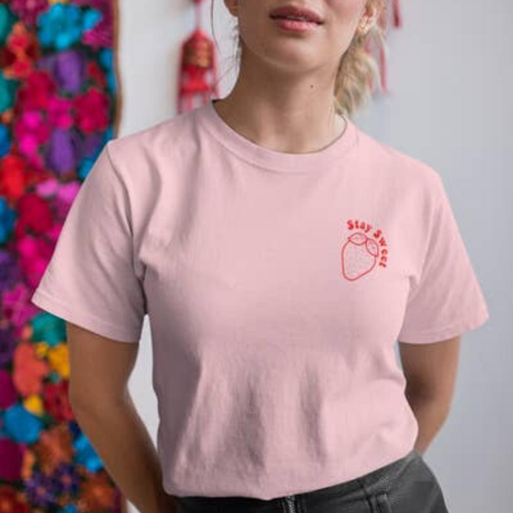 Light-pink ‘Stay Sweet’ graphic t-shirt by Funnel Cake Tree featuring a red strawberry outline design, cute and playful tee for everyday wear.